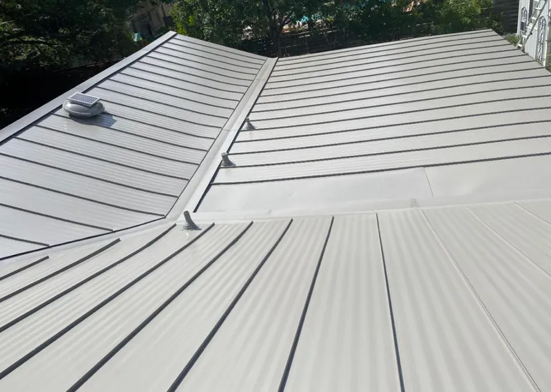 Solar attic fan installed on a metal roof for Roof Ventilation in St. Clair