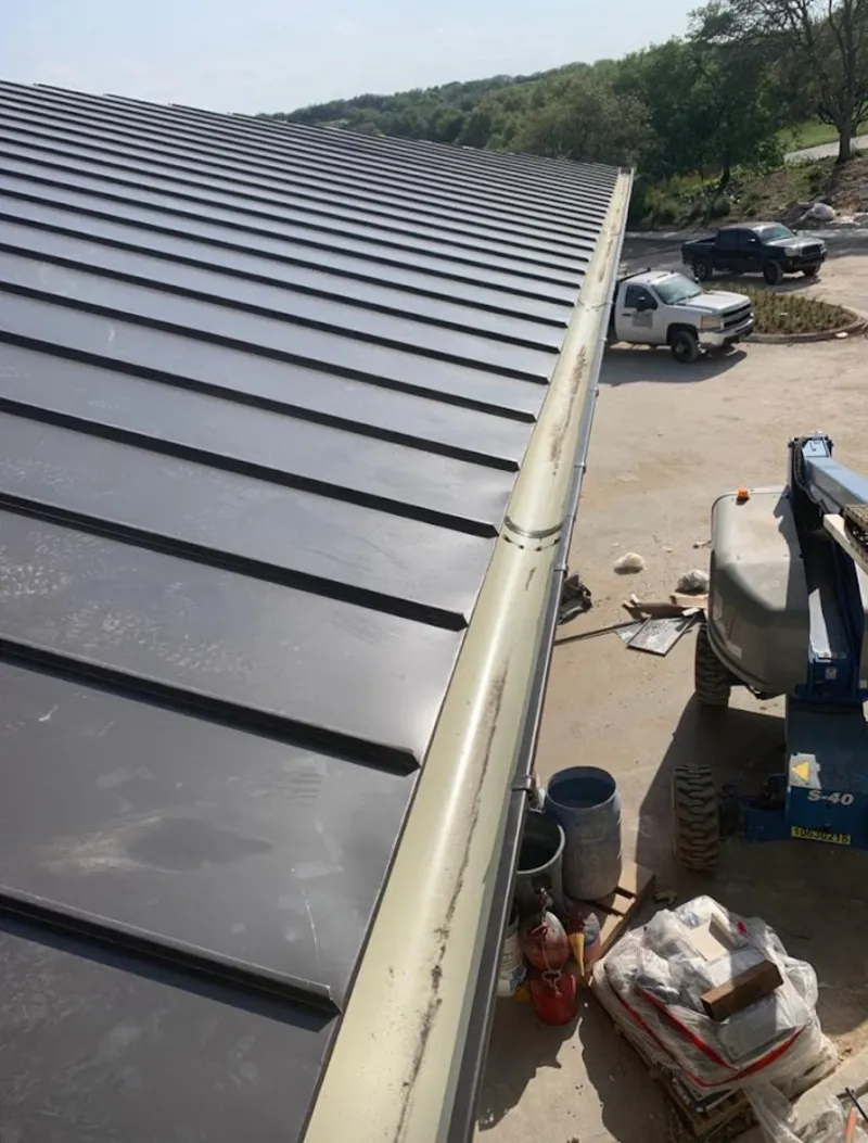 Standing seam panel and gutter detail on a metal roofing jobsite in St. Clair